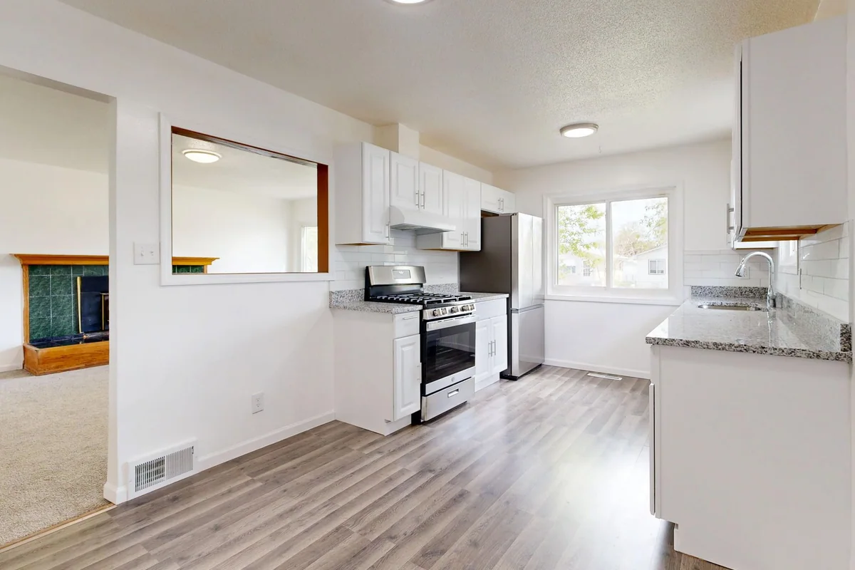 A folding dining chair and compact table stored against an apartment wall